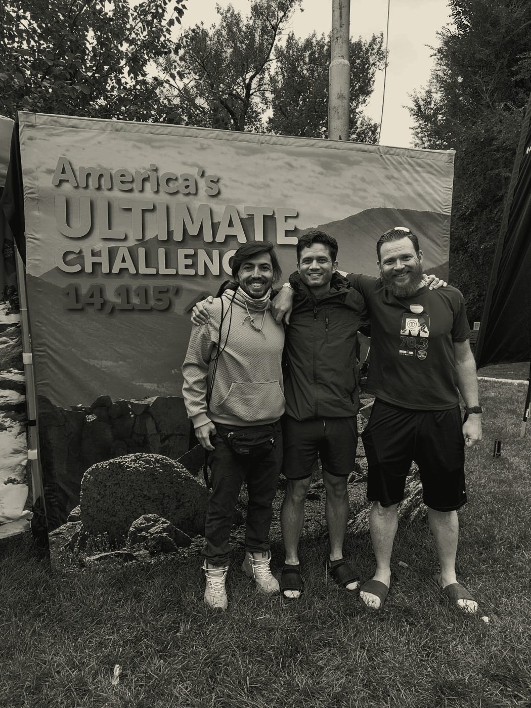Team beneath an ultra-challenge event banner